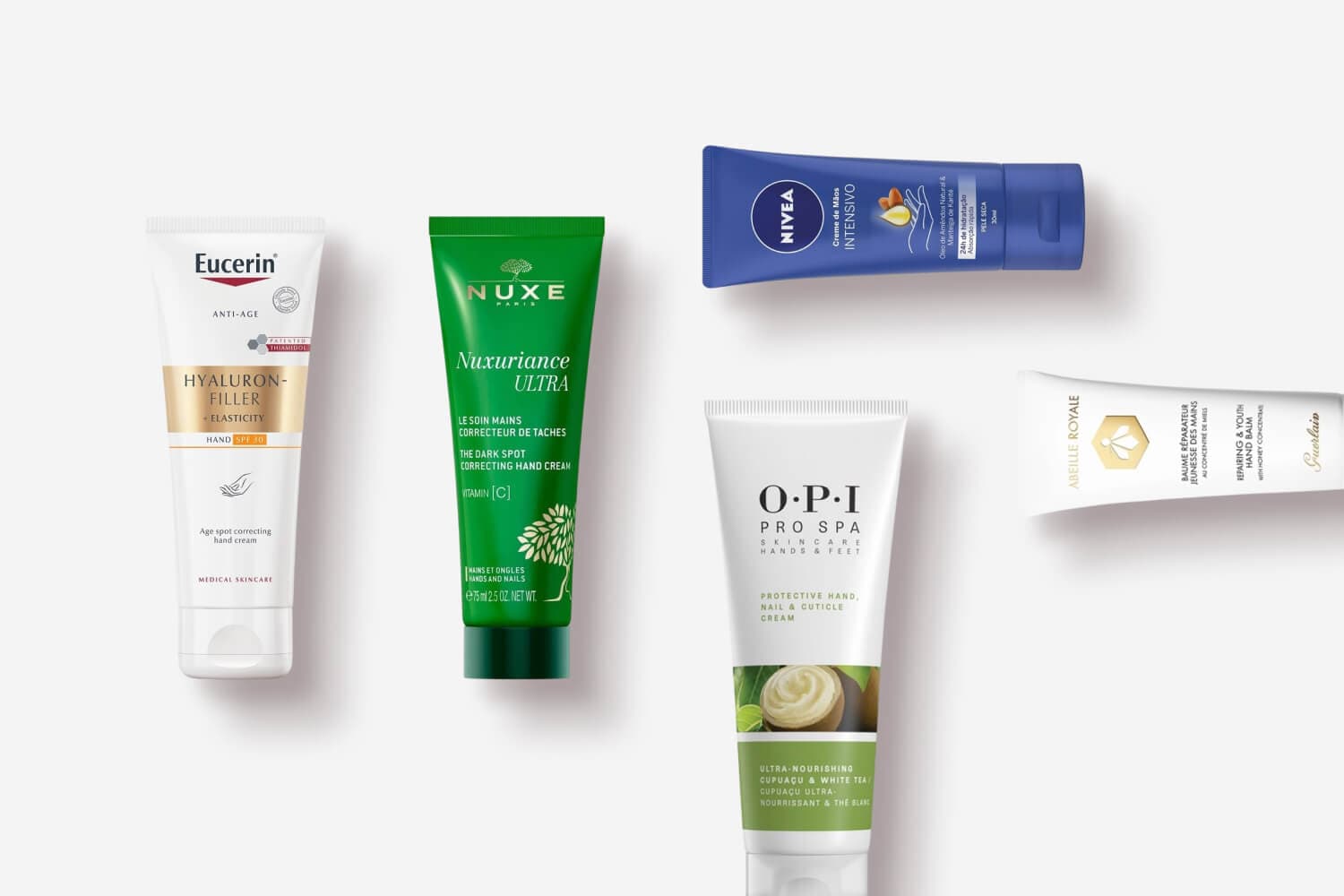 Eucerin Hyaluron-Filler, Nuxe Nuxuriance Ultra, Nivea Intensivo, OPI Pro Spa and Guerlain Abeille Royale hand cream tubes. Eucerin Hyaluron-Filler, Nuxe Nuxuriance Ultra, Nivea Intensivo, OPI Pro Spa and Guerlain Abeille Royale hand cream tubes.