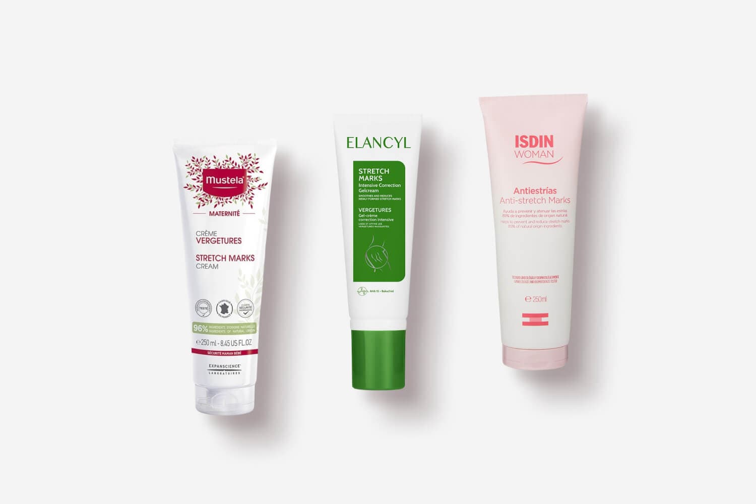 Mustela Maternité Stretch Marks Cream, Elancyl Stretch Marks Intensive Correction Gelcream and ISDIN Woman Antiestrías tubes on grey. Mustela Maternité Stretch Marks Cream, Elancyl Stretch Marks Intensive Correction Gelcream and ISDIN Woman Antiestrías tubes on grey.