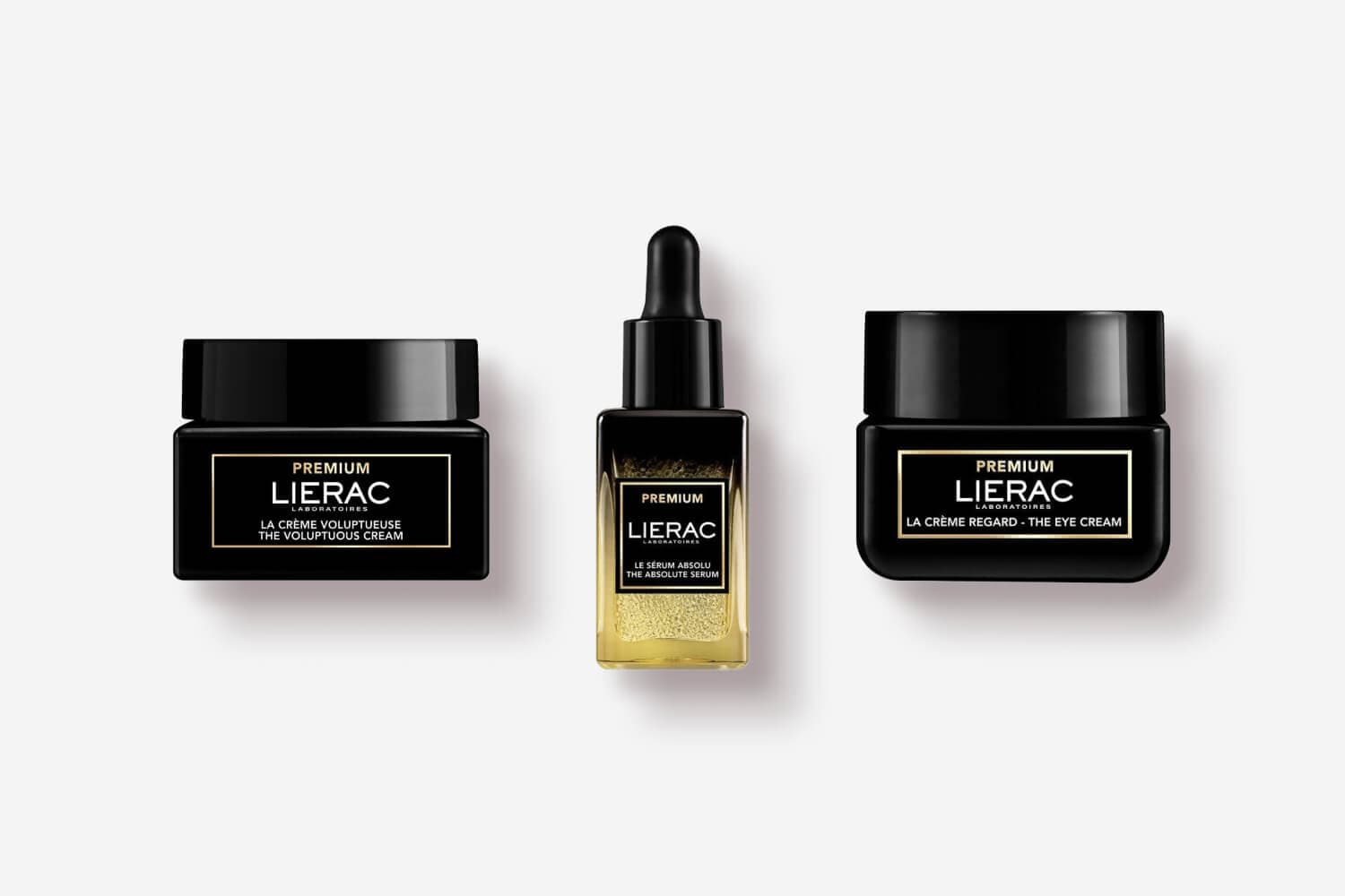 Three black-and-gold Lierac Premium products: The Voluptuous Cream jar, The Absolute Serum dropper bottle and The Eye Cream jar. Three black-and-gold Lierac Premium products: The Voluptuous Cream jar, The Absolute Serum dropper bottle and The Eye Cream jar.