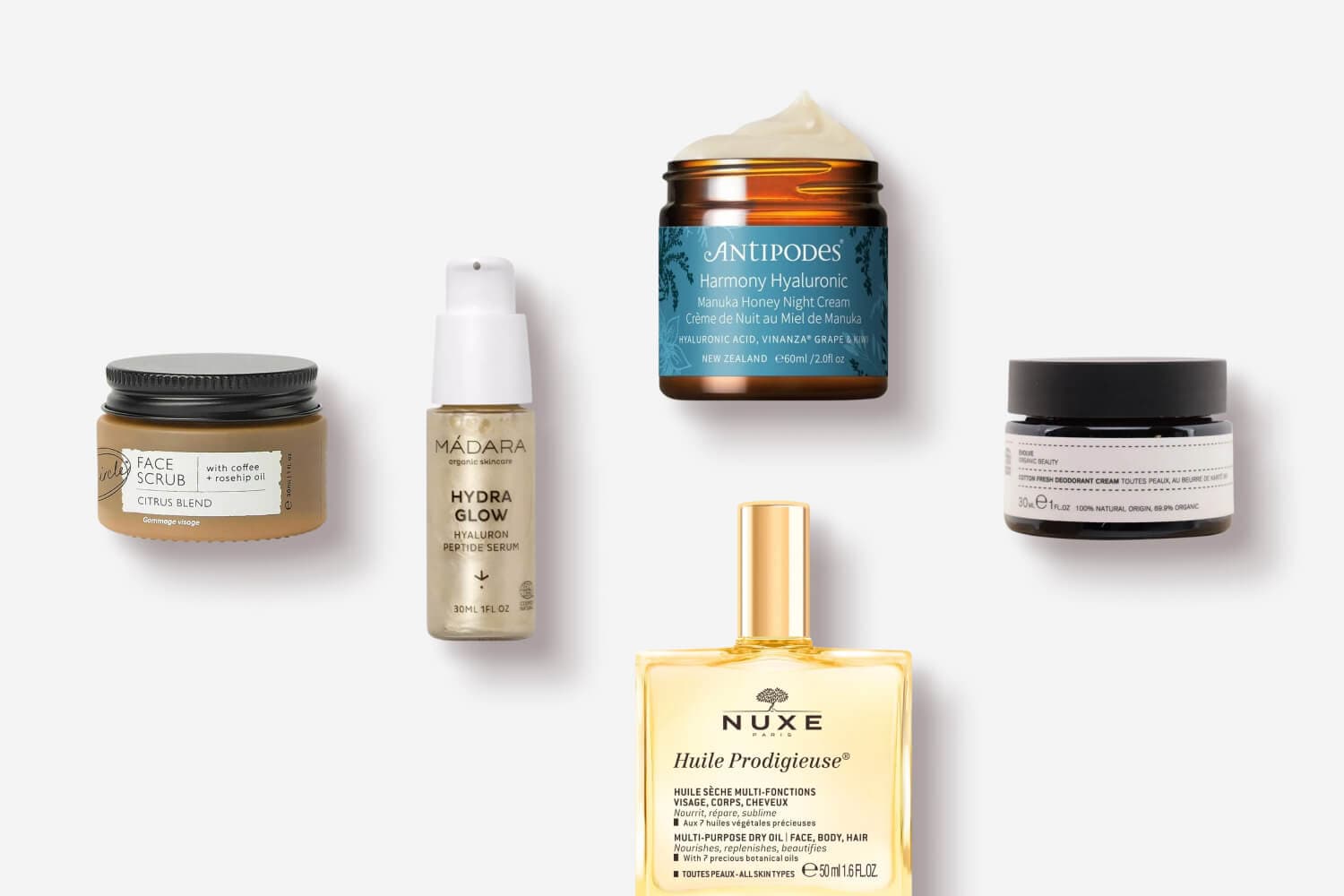Citrus Blend Face Scrub, Mádara Hydra Glow serum, Antipodes Harmony Hyaluronic night cream, Nuxe Huile Prodigieuse and a deodorant cream jar. Citrus Blend Face Scrub, Mádara Hydra Glow serum, Antipodes Harmony Hyaluronic night cream, Nuxe Huile Prodigieuse and a deodorant cream jar.
