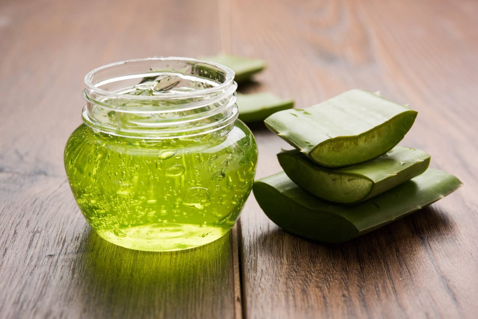 aloe pieces with jar of aloe gel aloe pieces with jar of aloe gel