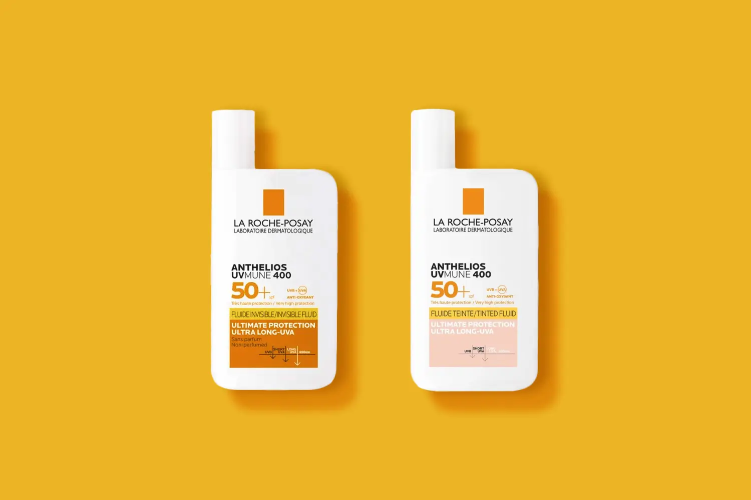 Two La Roche-Posay Anthelios UVMune 400 SPF 50+ bottles, Invisible Fluid and Tinted Fluid, on a yellow background. Two La Roche-Posay Anthelios UVMune 400 SPF 50+ bottles, Invisible Fluid and Tinted Fluid, on a yellow background.