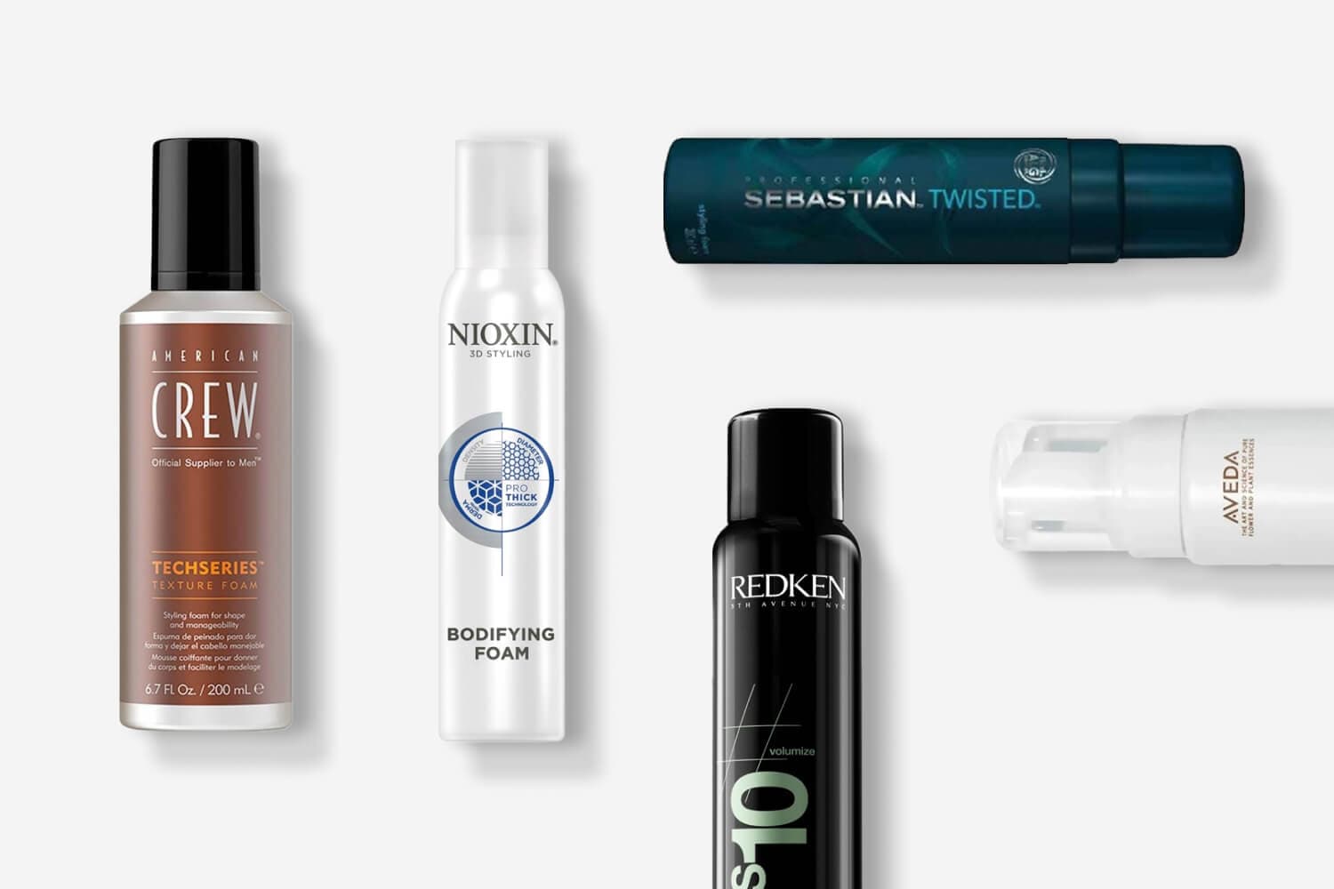 American Crew Techseries Texture Foam, Nioxin 3D Styling Bodifying Foam, Sebastian Twisted, Redken Volumize and Aveda bottles on grey. American Crew Techseries Texture Foam, Nioxin 3D Styling Bodifying Foam, Sebastian Twisted, Redken Volumize and Aveda bottles on grey.
