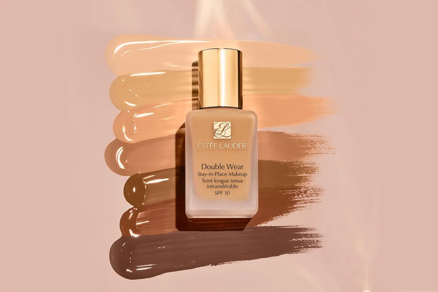 Estée Lauder Double Wear Stay-in-Place Makeup SPF 10 bottle on a fan of foundation swatches from fair to deep. Estée Lauder Double Wear Stay-in-Place Makeup SPF 10 bottle on a fan of foundation swatches from fair to deep.