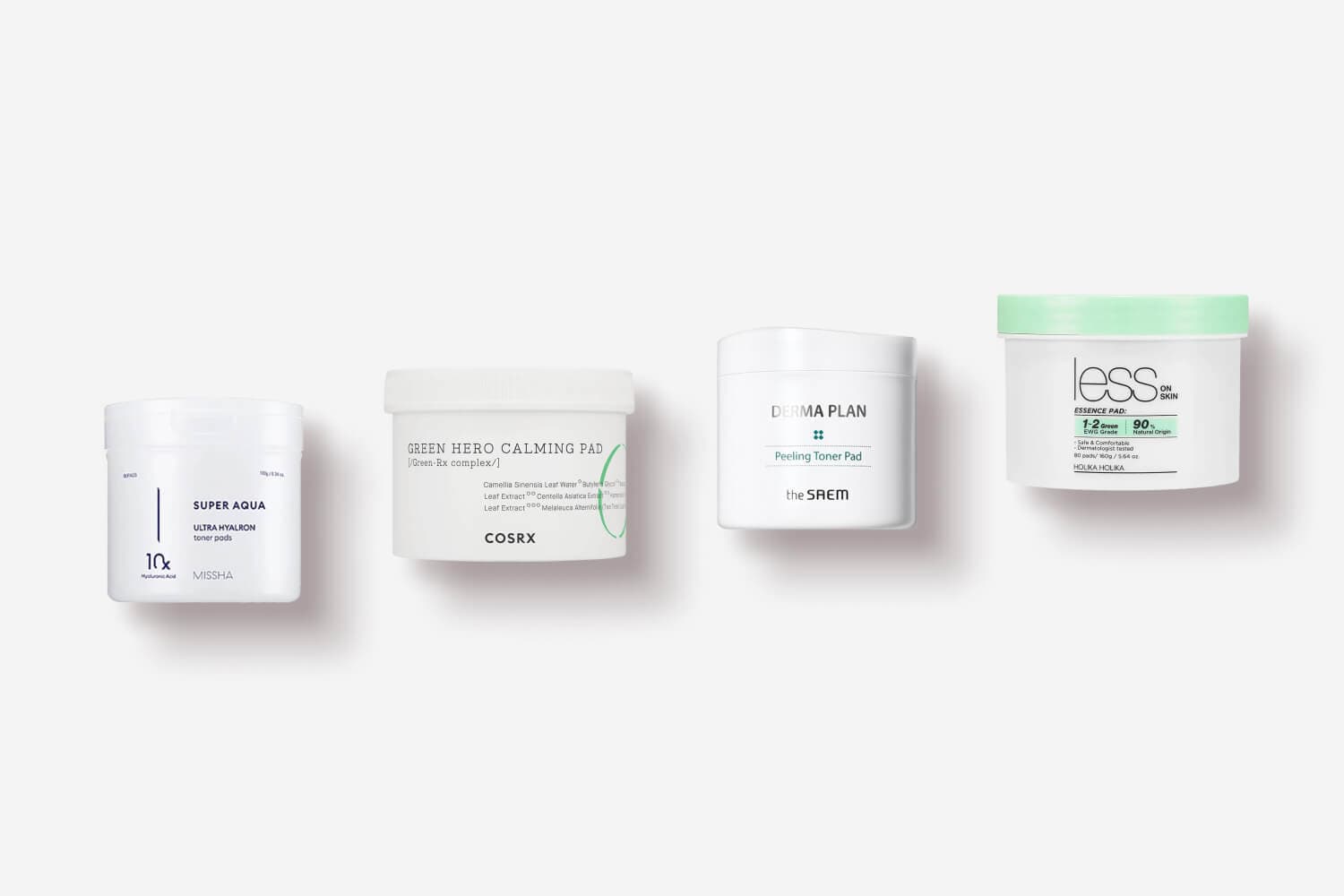 Four toner pad tubs in a row: Missha Super Aqua Ultra Hyalron, COSRX Green Hero Calming Pad, the SAEM Derma Plan Peeling, Holika Holika Less On Skin.