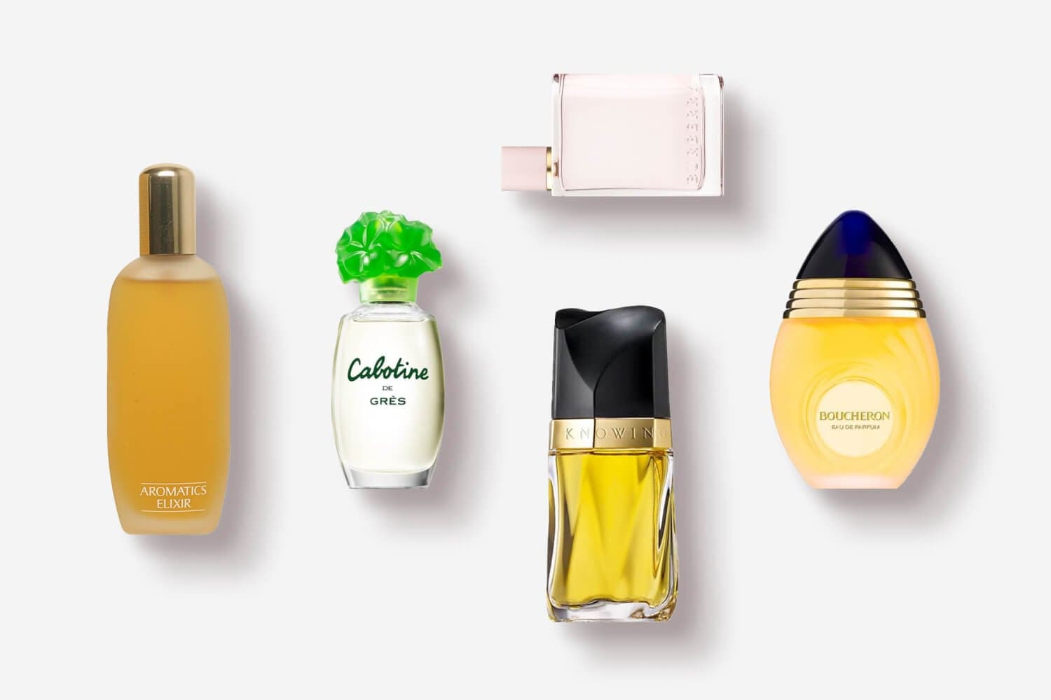 Aromatics Elixir, Cabotine de Grès, Burberry Brit, Estée Lauder Knowing and Boucheron Eau de Parfum bottles on grey. Aromatics Elixir, Cabotine de Grès, Burberry Brit, Estée Lauder Knowing and Boucheron Eau de Parfum bottles on grey.