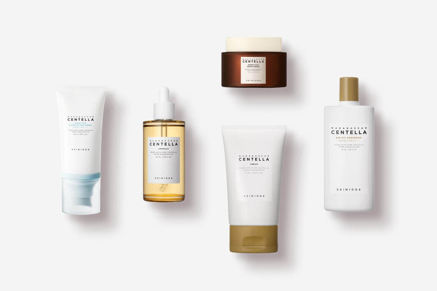 SKIN1004 Madagascar Centella line on grey: Hyalu-Cica Water-Fit Sun Serum, Ampoule, Probio-Cica Enrich Cream, Cream and Air-Fit Suncream. SKIN1004 Madagascar Centella line on grey: Hyalu-Cica Water-Fit Sun Serum, Ampoule, Probio-Cica Enrich Cream, Cream and Air-Fit Suncream.