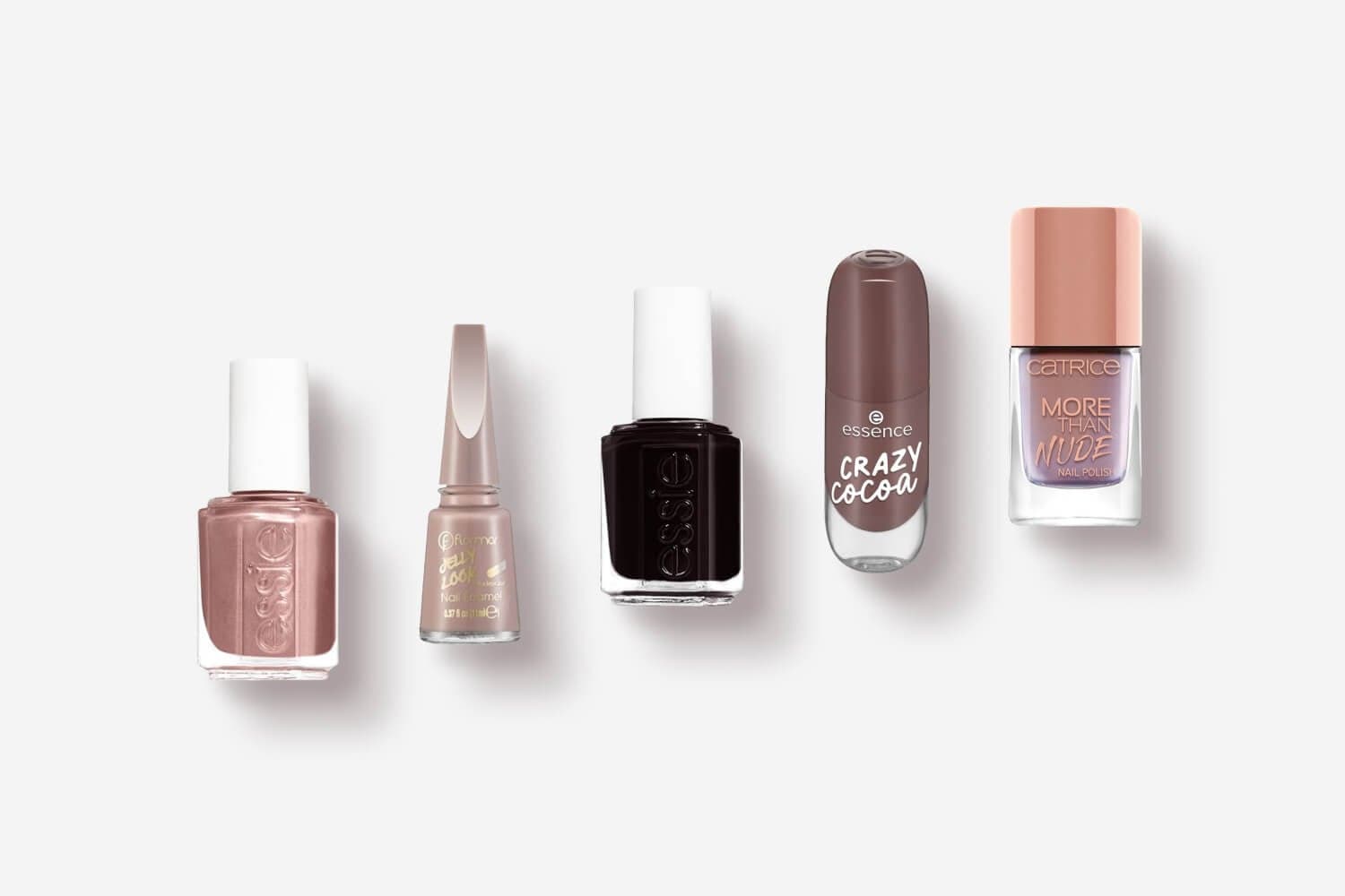 Five nail polish bottles on grey: rose-gold Essie, Flormar Jelly Look Nail Enamel, dark Essie, essence Crazy Cocoa and Catrice More Than Nude. Five nail polish bottles on grey: rose-gold Essie, Flormar Jelly Look Nail Enamel, dark Essie, essence Crazy Cocoa and Catrice More Than Nude.