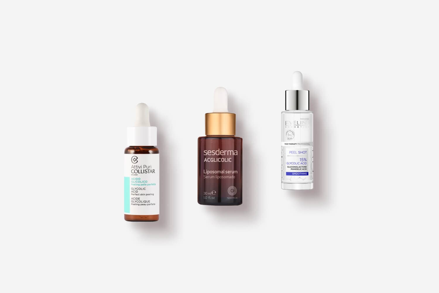 Three dropper bottles on grey: Collistar Attivi Puri Acido Glicolico, Sesderma Acglicolic Liposomal Serum and Eveline Peel Shot 15% Glycolic Acid. Three dropper bottles on grey: Collistar Attivi Puri Acido Glicolico, Sesderma Acglicolic Liposomal Serum and Eveline Peel Shot 15% Glycolic Acid.