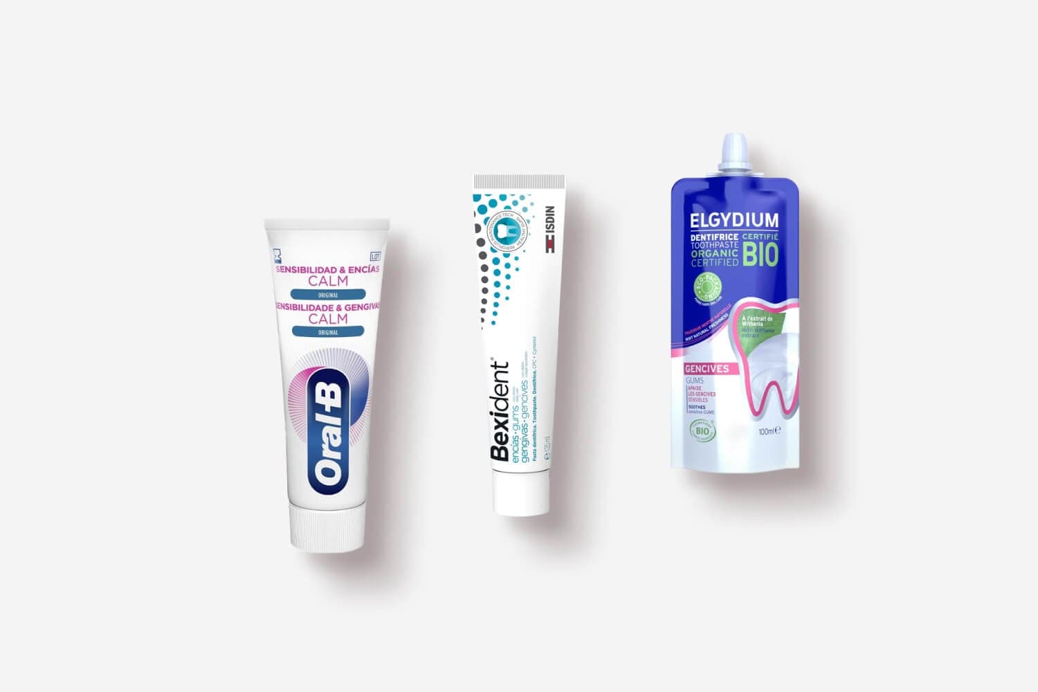 Oral-B Sensitivity & Gums Calm Original, Isdin Bexident Gums toothpaste and Elgydium Bio Gums 100ml on a grey background. Oral-B Sensitivity & Gums Calm Original, Isdin Bexident Gums toothpaste and Elgydium Bio Gums 100ml on a grey background.