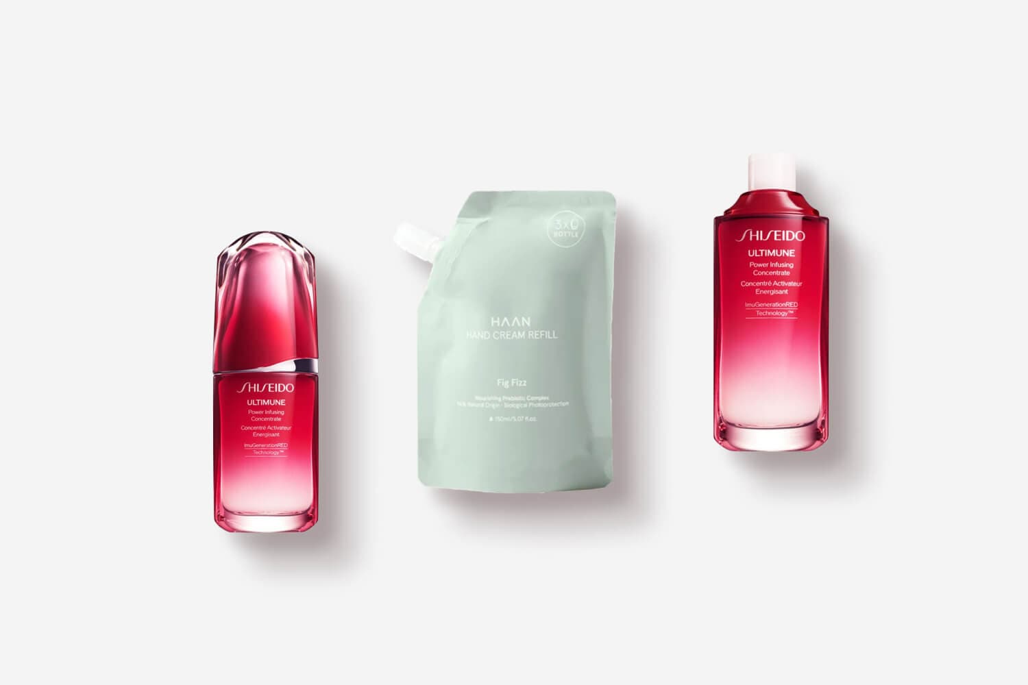 Shiseido Ultimune Power Infusing Concentrate bottle and its refill flanking a green HAAN Fig Fizz hand cream refill pouch. Shiseido Ultimune Power Infusing Concentrate bottle and its refill flanking a green HAAN Fig Fizz hand cream refill pouch.