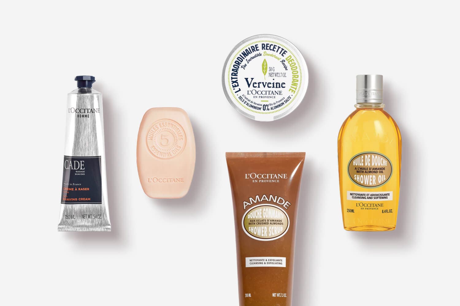 L'Occitane Cade Shaving Cream, 5 Essential Oils soap, Verveine deodorant, Amande Shower Scrub and Almond Shower Oil on grey L'Occitane Cade Shaving Cream, 5 Essential Oils soap, Verveine deodorant, Amande Shower Scrub and Almond Shower Oil on grey