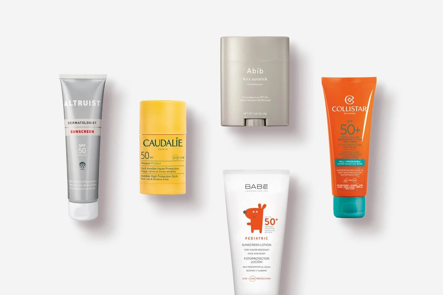 Altruist SPF 50, Caudalie Vinosun Protect stick, Abib Airy Sunstick, BABE Pediatric SPF 50+ and Collistar SPF 50+ on grey Altruist SPF 50, Caudalie Vinosun Protect stick, Abib Airy Sunstick, BABE Pediatric SPF 50+ and Collistar SPF 50+ on grey