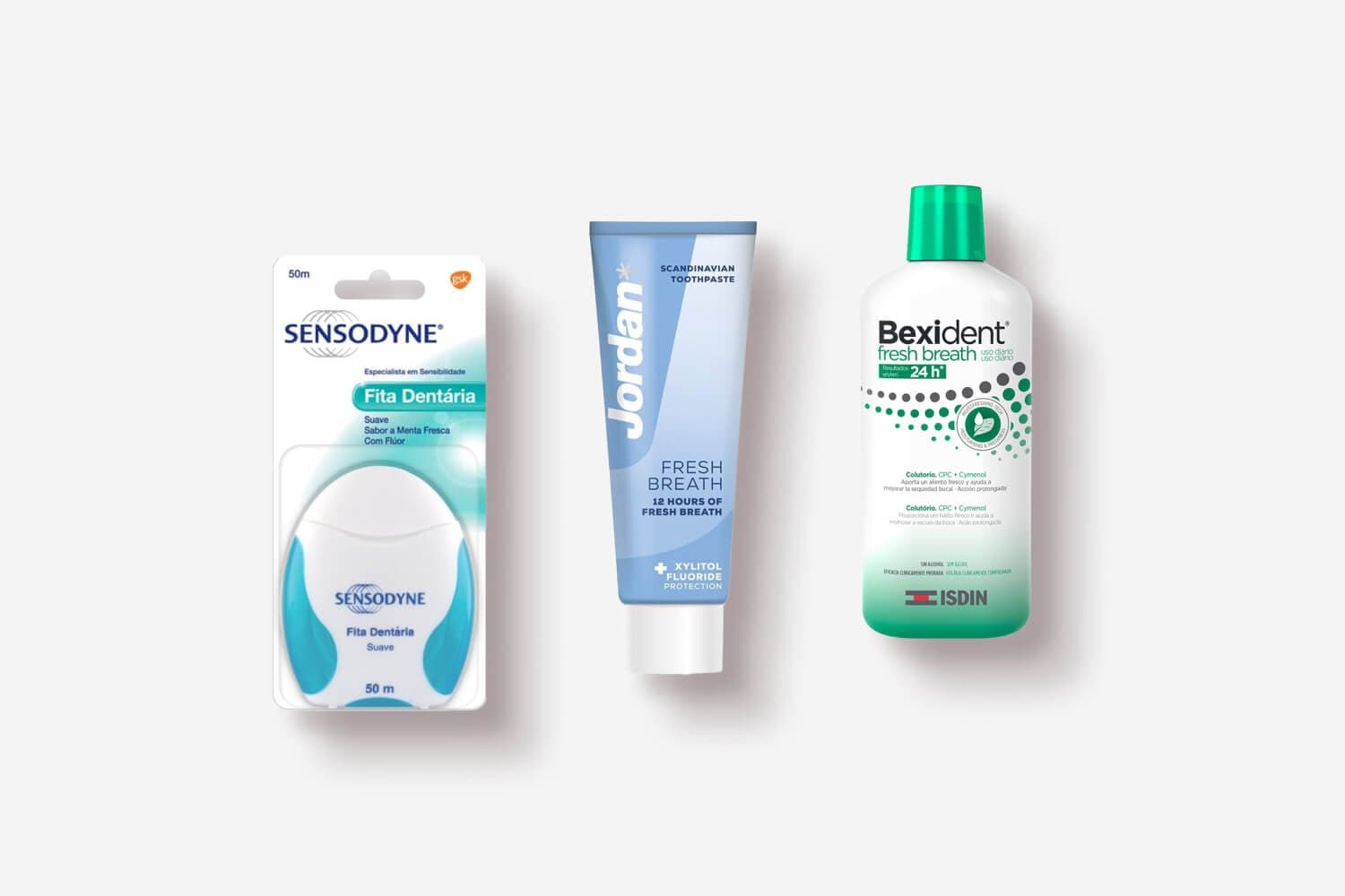 Sensodyne Fita Dentária 50m dental tape, Jordan Fresh Breath toothpaste and Isdin Bexident Fresh Breath mouthwash on grey. Sensodyne Fita Dentária 50m dental tape, Jordan Fresh Breath toothpaste and Isdin Bexident Fresh Breath mouthwash on grey.