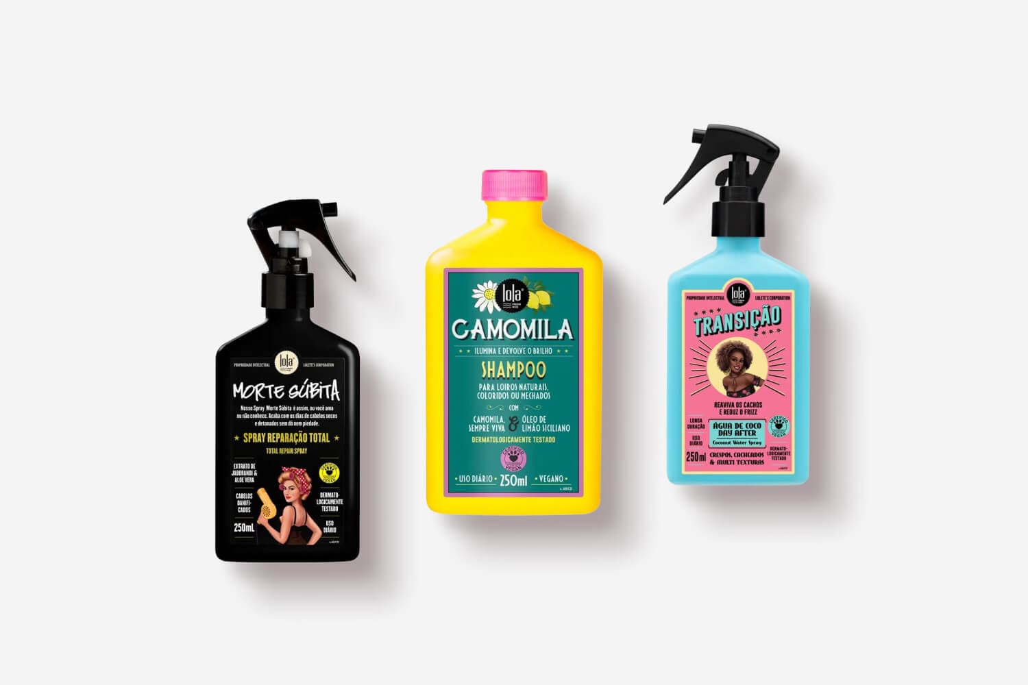 Three Lola Cosmetics 250 ml bottles on white: black Morte Súbita repair spray, yellow Camomila shampoo and blue Transição coconut water spray. Three Lola Cosmetics 250 ml bottles on white: black Morte Súbita repair spray, yellow Camomila shampoo and blue Transição coconut water spray.