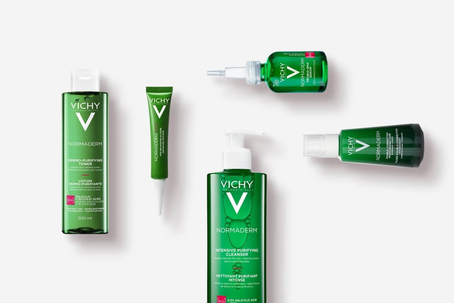 Vichy Normaderm Dermo-Purifying Toner, S.O.S. Anti-Spot Paste, Probio-BHA Serum, Intensive Purifying Cleanser and Double-Correction fluid on grey Vichy Normaderm Dermo-Purifying Toner, S.O.S. Anti-Spot Paste, Probio-BHA Serum, Intensive Purifying Cleanser and Double-Correction fluid on grey