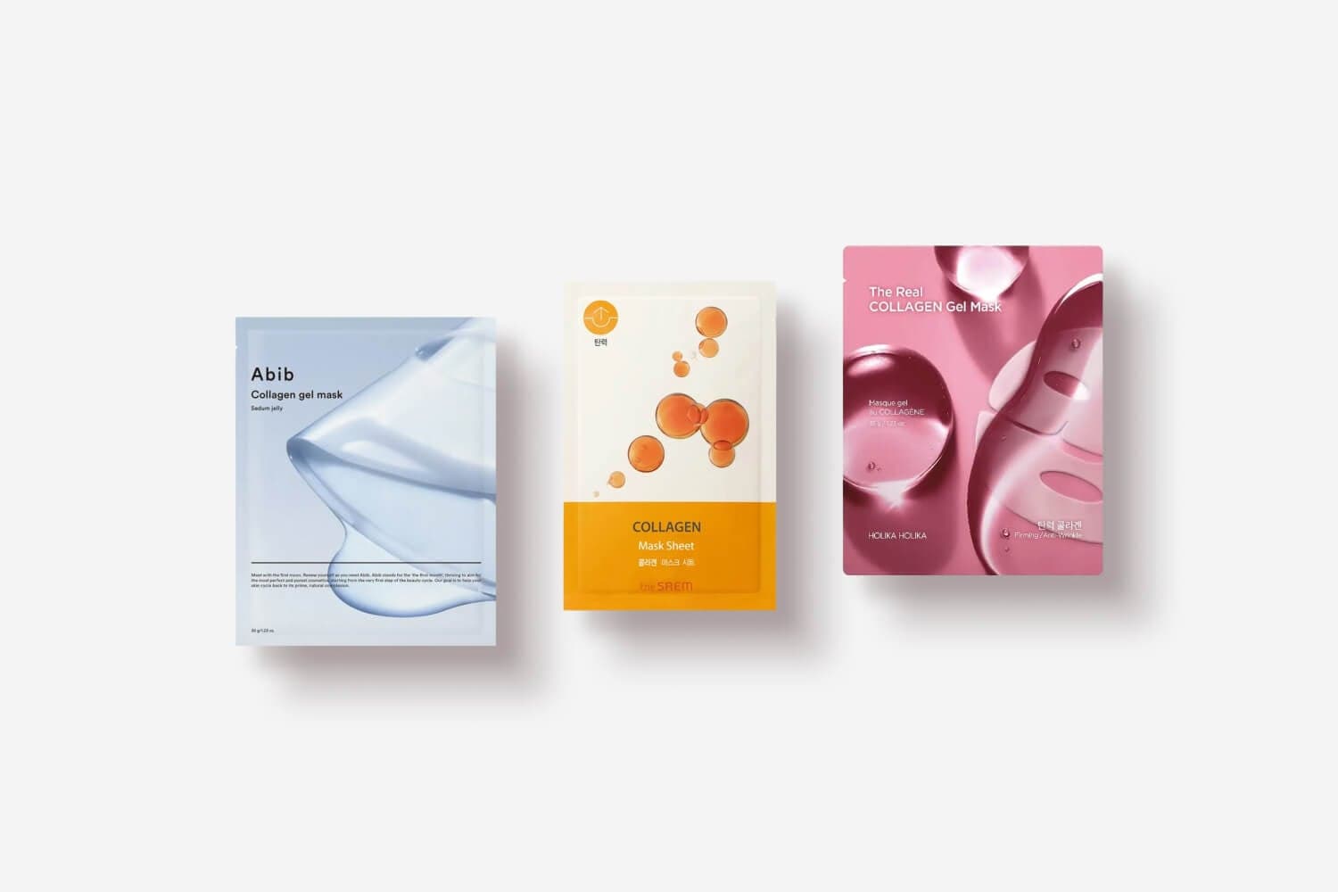 Three sheet mask sachets on white: Abib Collagen Gel Mask Sedum Jelly, The Saem Collagen Mask Sheet, and Holika Holika The Real Collagen Gel Mask. Three sheet mask sachets on white: Abib Collagen Gel Mask Sedum Jelly, The Saem Collagen Mask Sheet, and Holika Holika The Real Collagen Gel Mask.