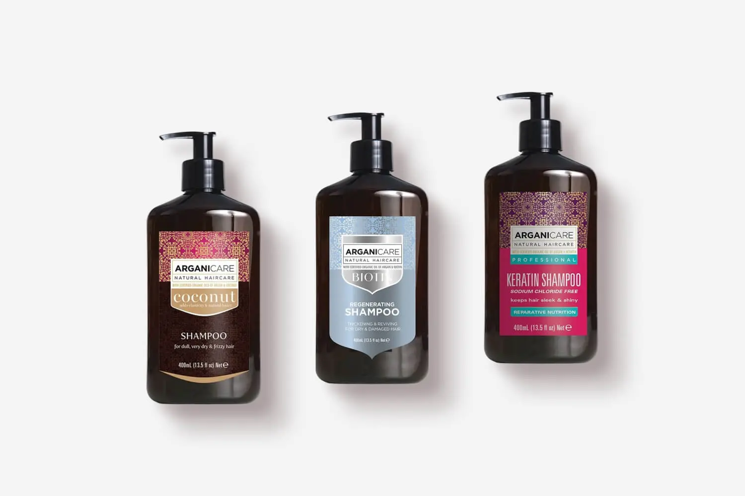 Three 400 ml Arganicare pump bottles side by side: Coconut Shampoo, Biotin Regenerating Shampoo and Professional Keratin Shampoo. Three 400 ml Arganicare pump bottles side by side: Coconut Shampoo, Biotin Regenerating Shampoo and Professional Keratin Shampoo.